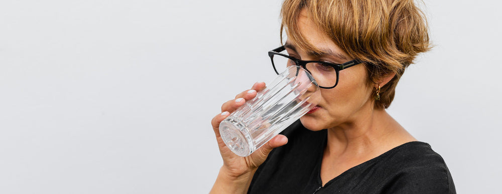 middle aged woman drinking water