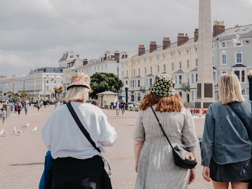 Three women walking in a plaza