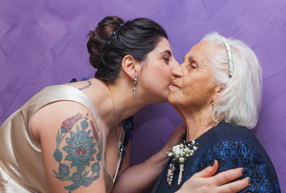 young woman kissing older woman on cheek